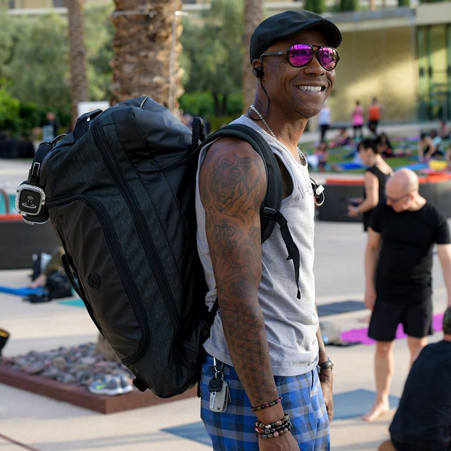 Dray Gardner from silent savasana wearing the mantisyoga retreat duffel backpack