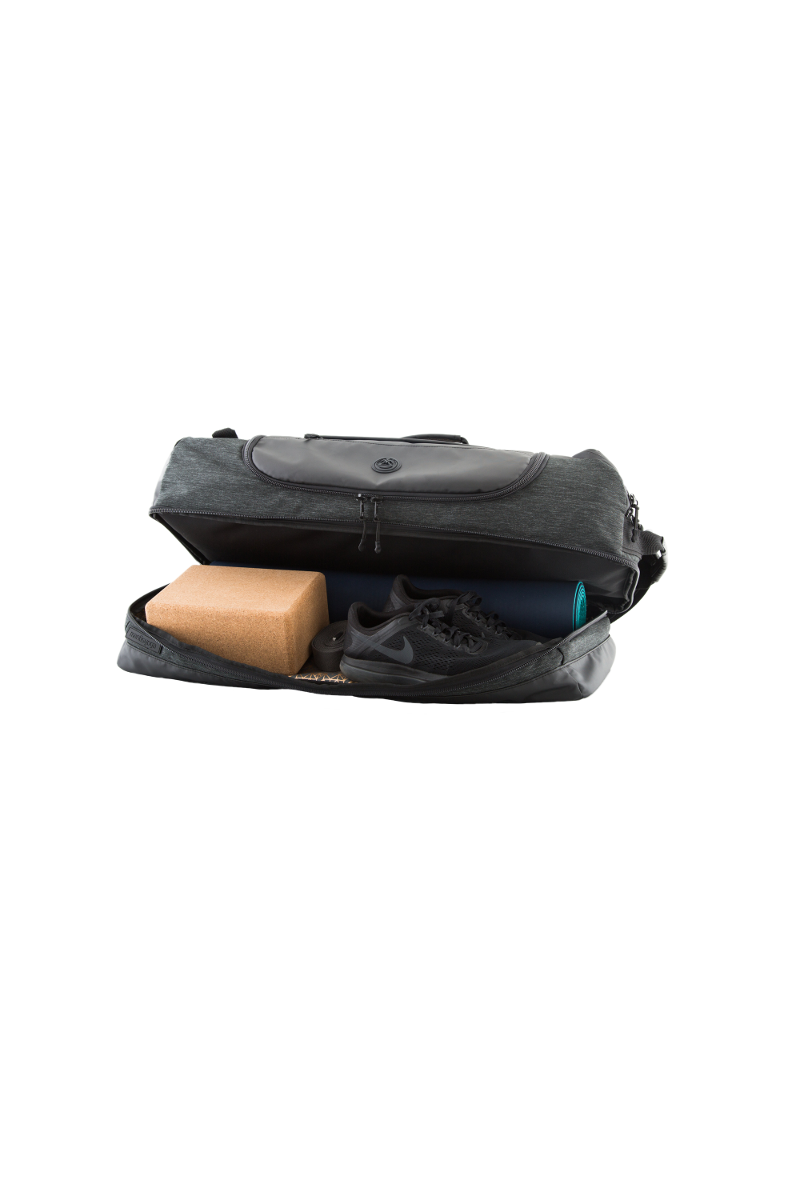 retreat duffel pack slightly open with yoga mat and yoga gear in base