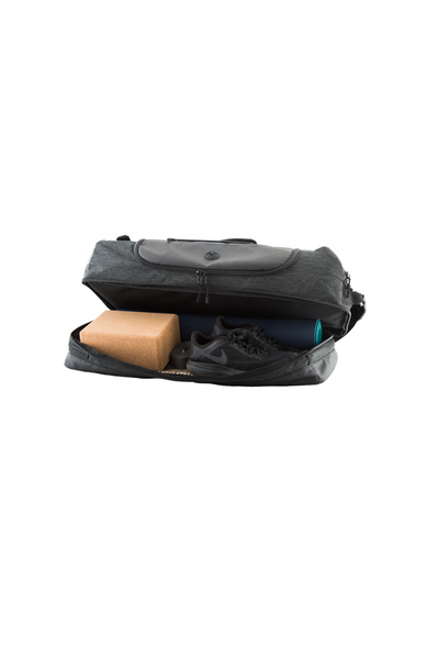 retreat duffel pack slightly open with yoga mat and yoga gear in base